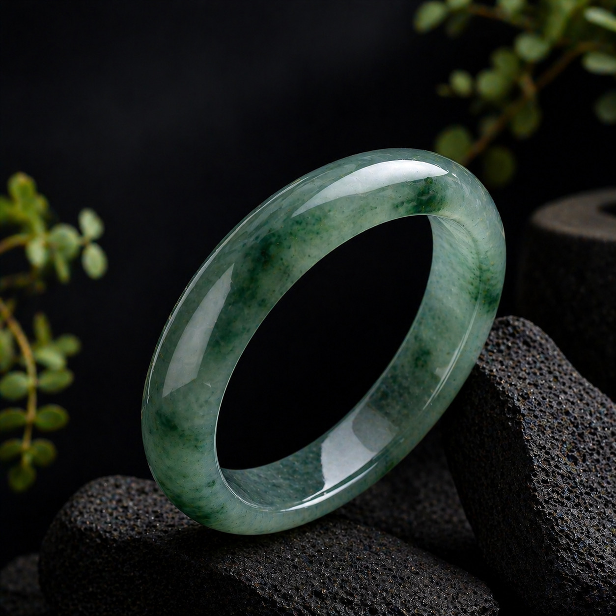 Jadeite bangle under darker indoor lighting showing mood and translucency