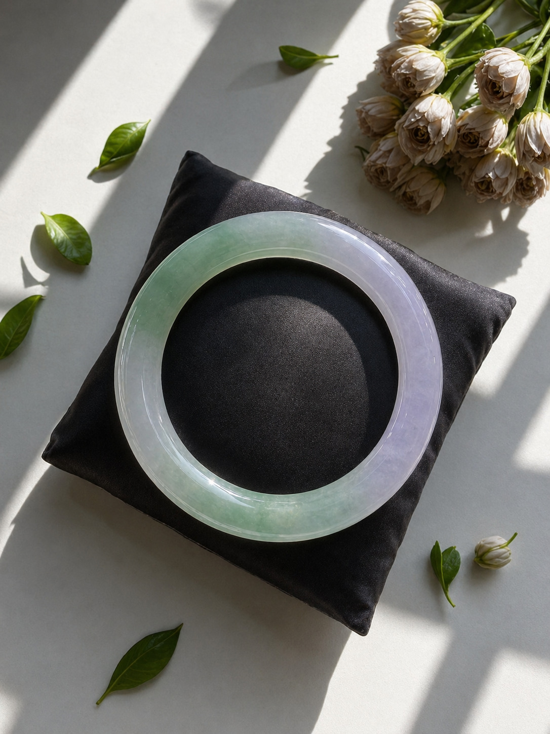 Jadeite bangles displayed in Singapore showing different tones and surface polish